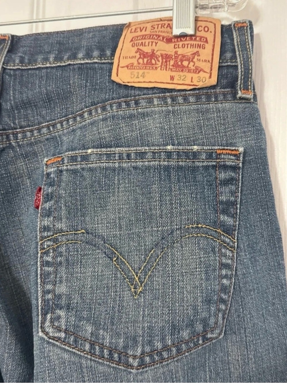 Levi's 514 Slim Straight jeans in a medium wash with light whiskering and fading